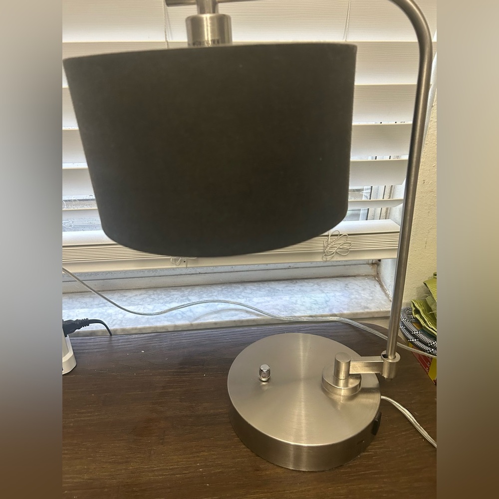 Modern Black and Silver Table Lamp convenient extra outlet on the base.